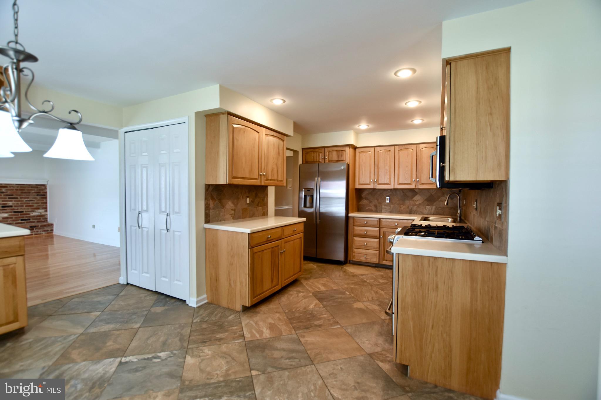 44 West Brookline Drive Laurel Springs, NJ 08021 - Photo 8 of 39 a kitchen with a refrigerator and a stove top oven