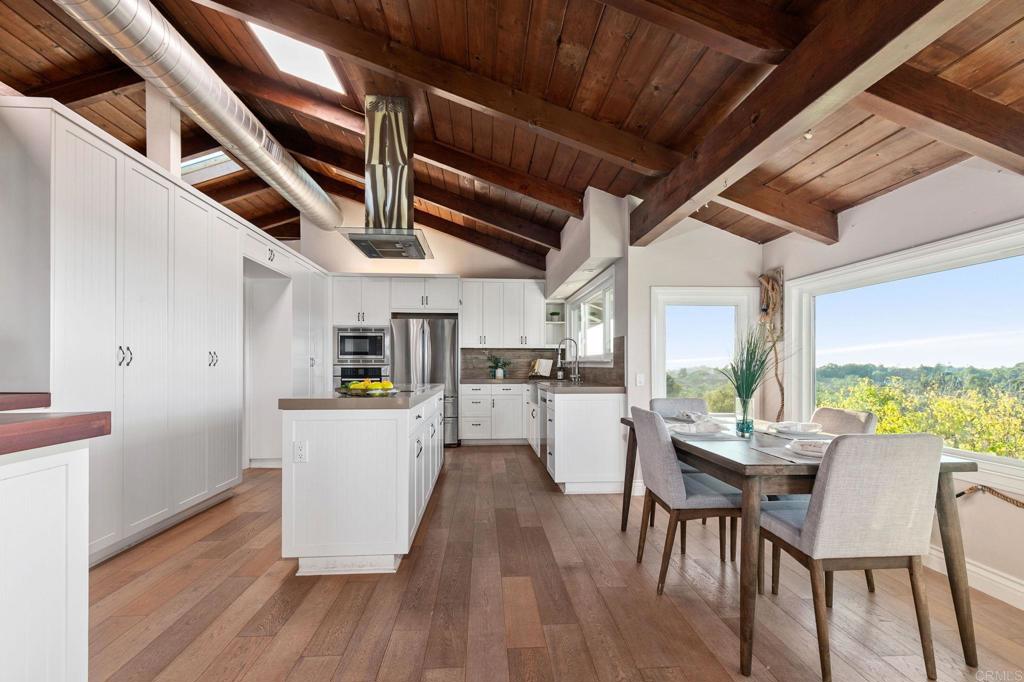 1628 Lone Oak Road Vista, CA 92084 - Photo 13 of 39 a view of a dining room with furniture window and wooden floor