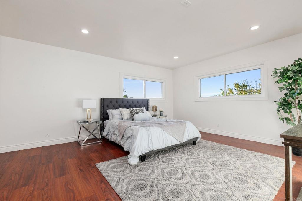 1628 Lone Oak Road Vista, CA 92084 - Photo 25 of 39 a bed room with a bed and a painting on the wall