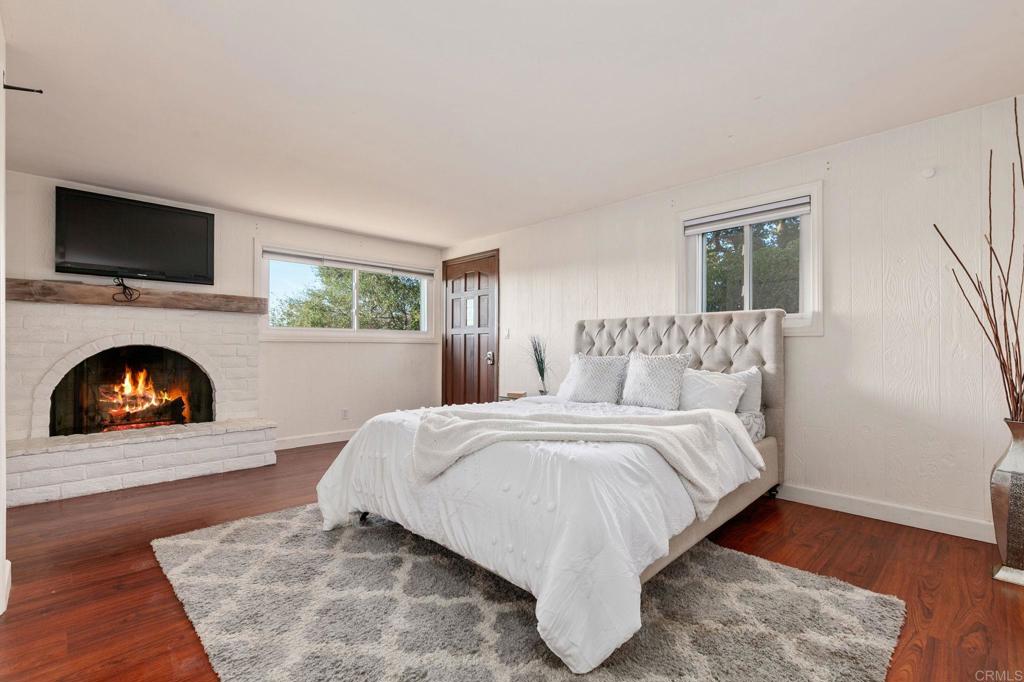 1628 Lone Oak Road Vista, CA 92084 - Photo 26 of 39 a spacious bedroom with a bed and a fireplace