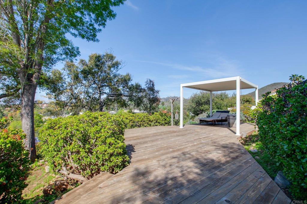 1628 Lone Oak Road Vista, CA 92084 - Photo 34 of 39 a backyard of a house with large trees and plants
