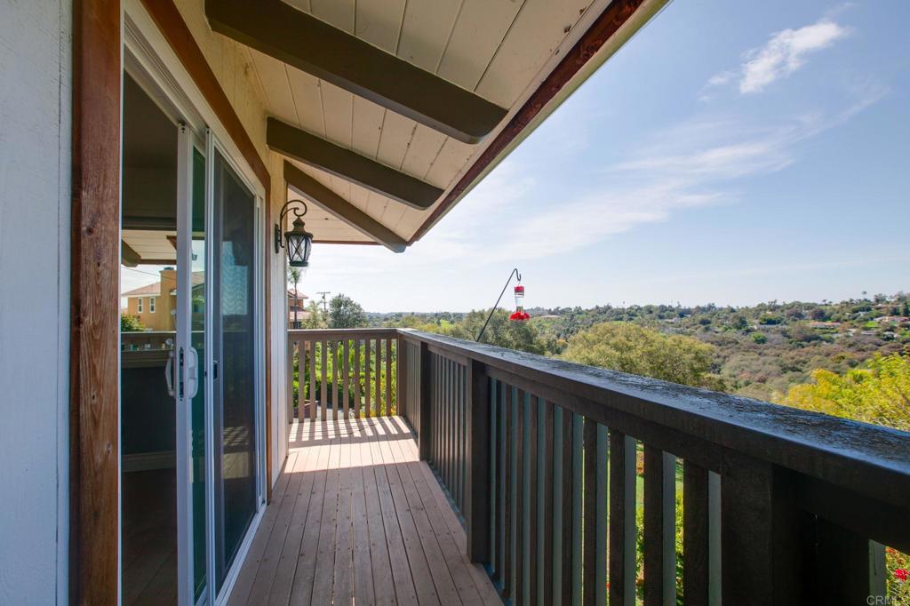 1628 Lone Oak Road Vista, CA 92084 - Photo 9 of 39 a view of a balcony with wooden floor and fence