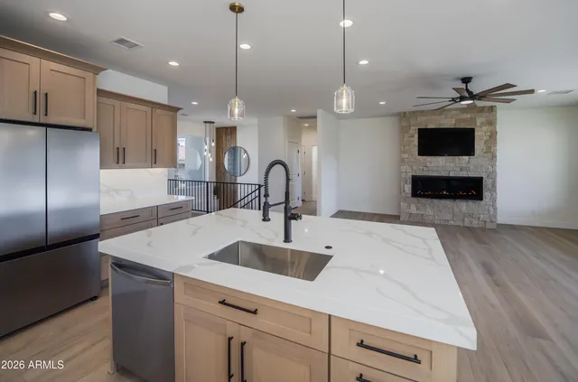 a kitchen with kitchen island a sink stainless steel appliances and cabinets