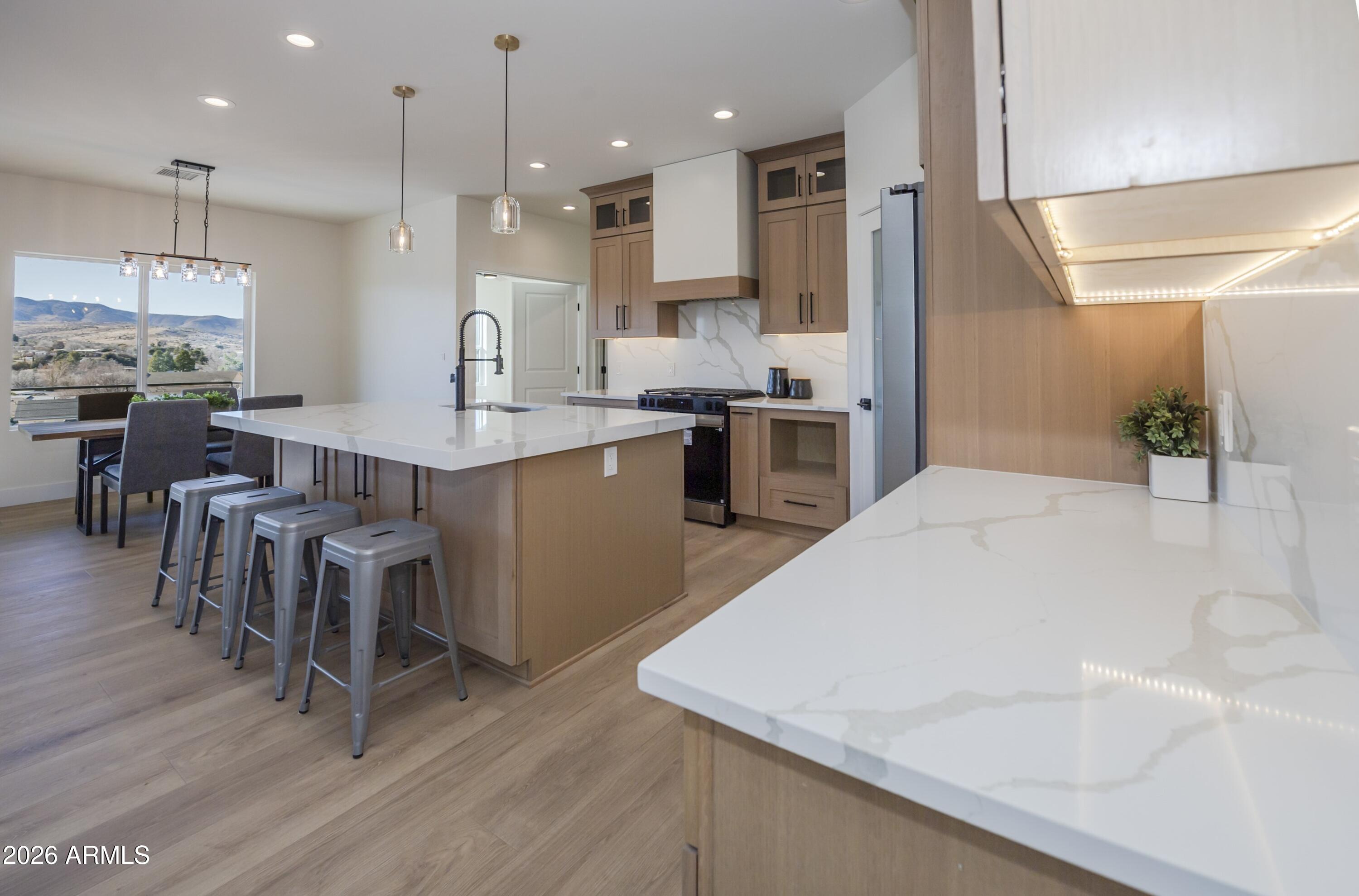 10603 Straight Arrow Road Dewey, AZ 86327 - Photo 13 of 57 a large kitchen with kitchen island a sink table and chairs