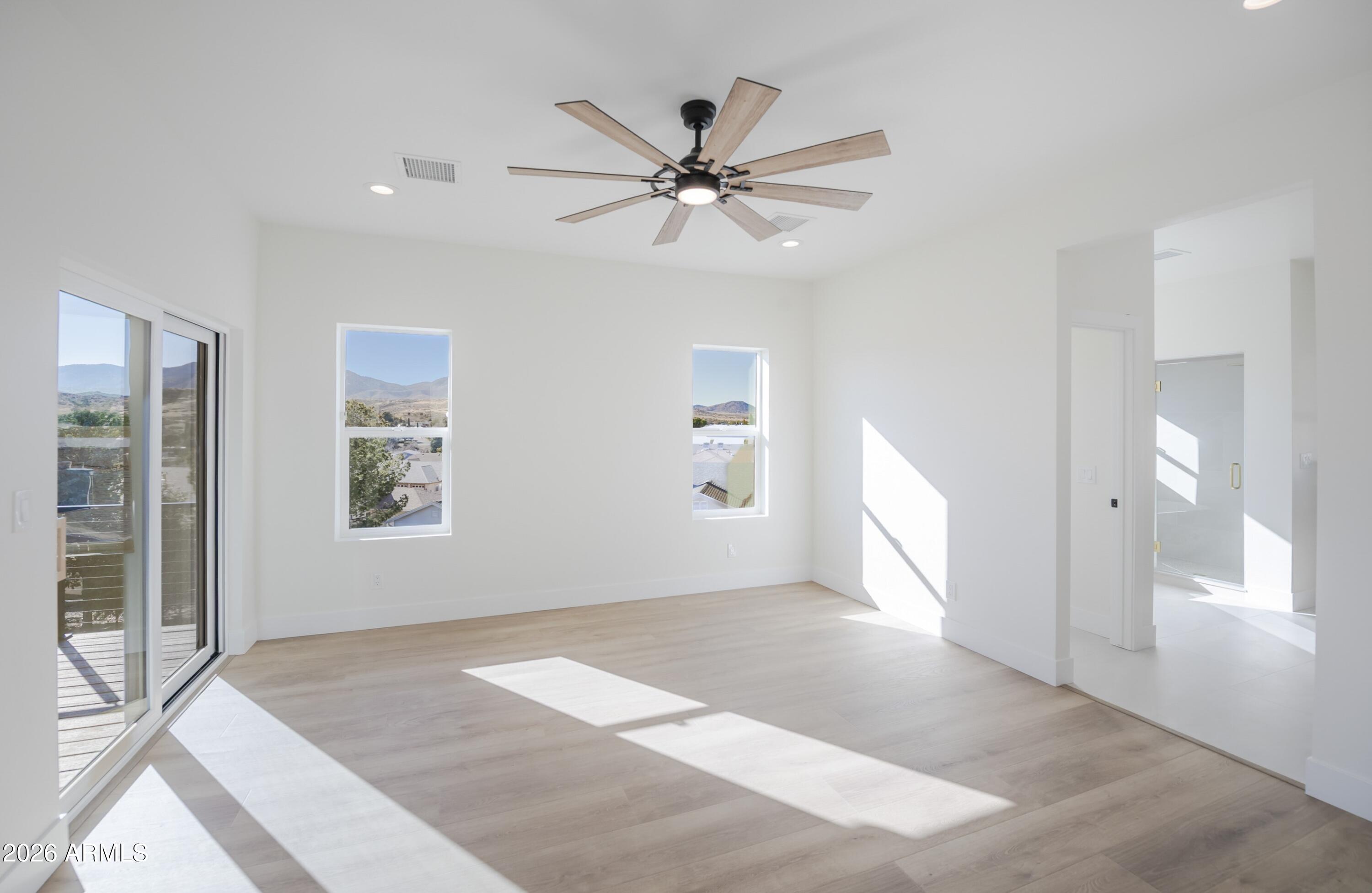 10603 Straight Arrow Road Dewey, AZ 86327 - Photo 15 of 57 a view of a livingroom with a ceiling fan & windows