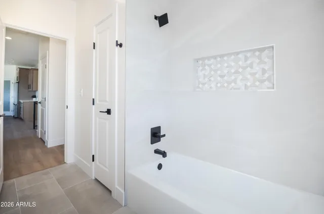 an empty room with a window and a ceiling fan