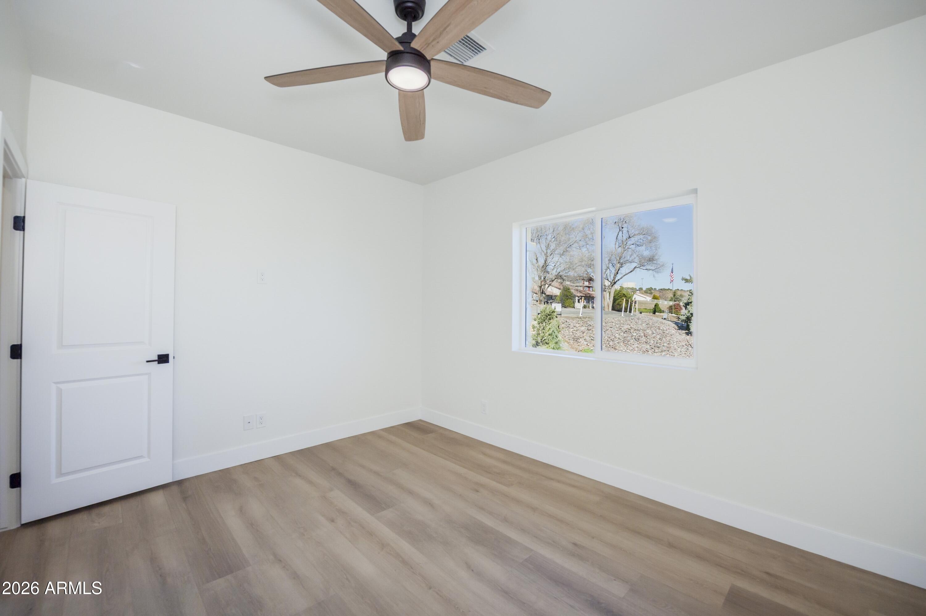 10603 Straight Arrow Road Dewey, AZ 86327 - Photo 24 of 57 an empty room with a window and a ceiling fan
