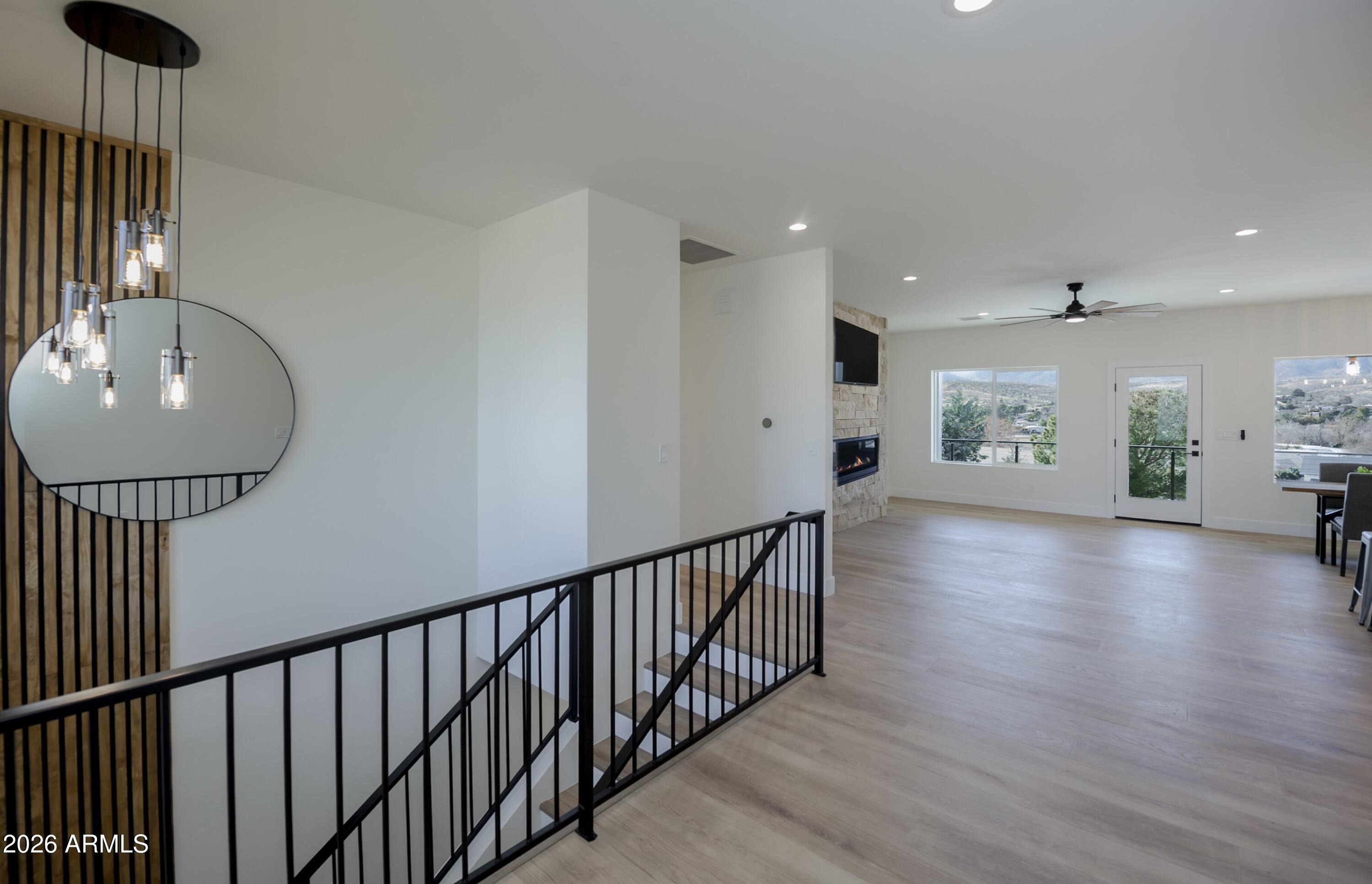 10603 Straight Arrow Road Dewey, AZ 86327 - Photo 3 of 57 a view of a hallway view with wooden floor and staircase