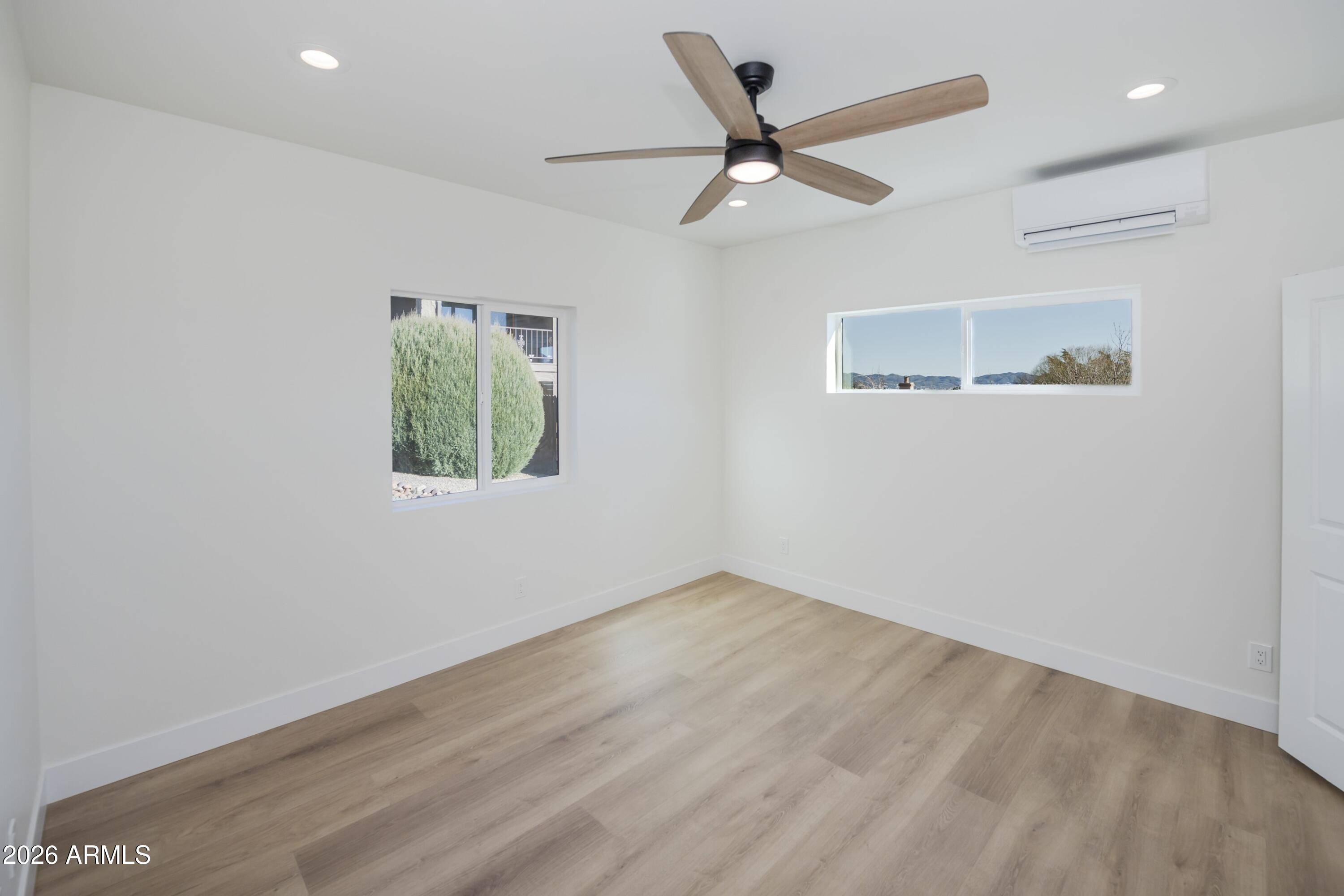 10603 Straight Arrow Road Dewey, AZ 86327 - Photo 34 of 57 an empty room with wooden floor ceiling fan and window