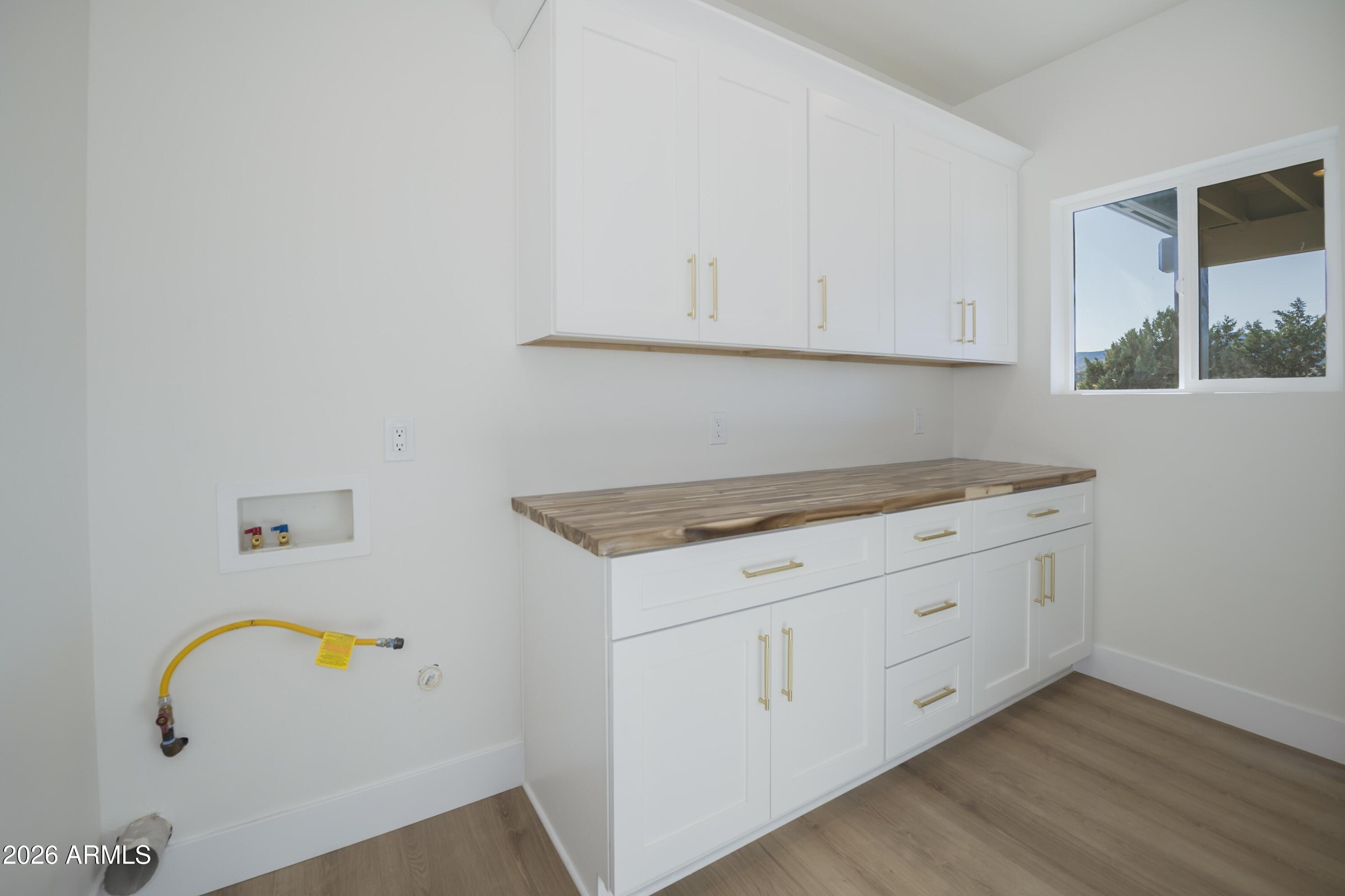 10603 Straight Arrow Road Dewey, AZ 86327 - Photo 37 of 57 a kitchen with granite countertop white cabinets and sink