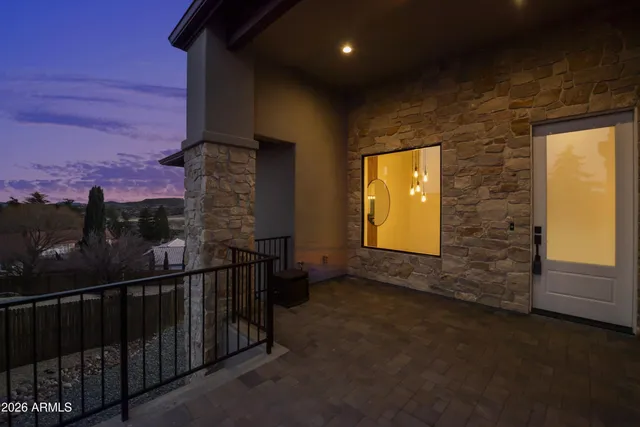 a view of a balcony with chairs and wooden floor