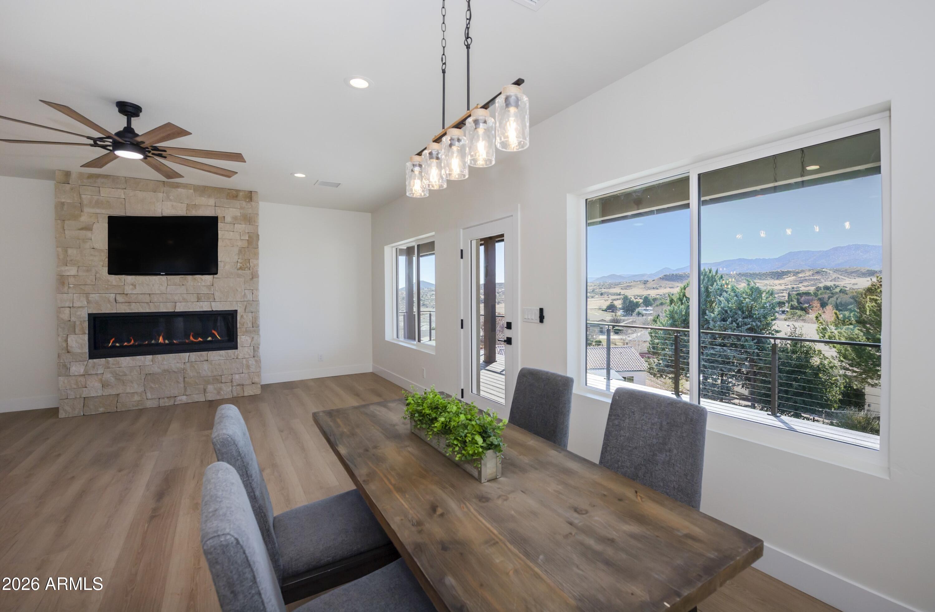 10603 Straight Arrow Road Dewey, AZ 86327 - Photo 6 of 57 a living room with furniture a fireplace and a flat screen tv