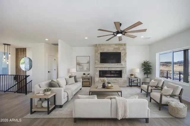 a living room with fireplace furniture and a flat screen tv