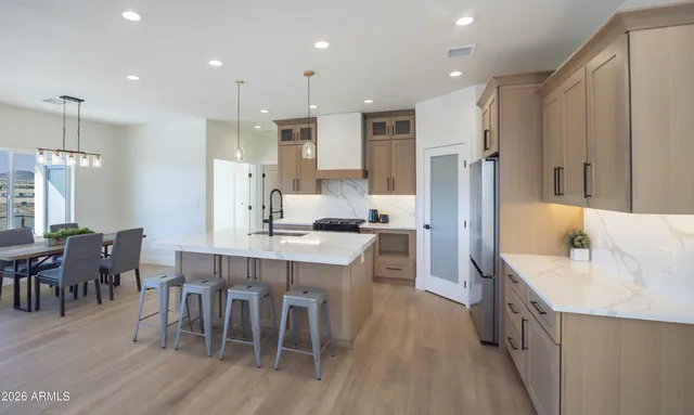 a large kitchen with a table and chairs