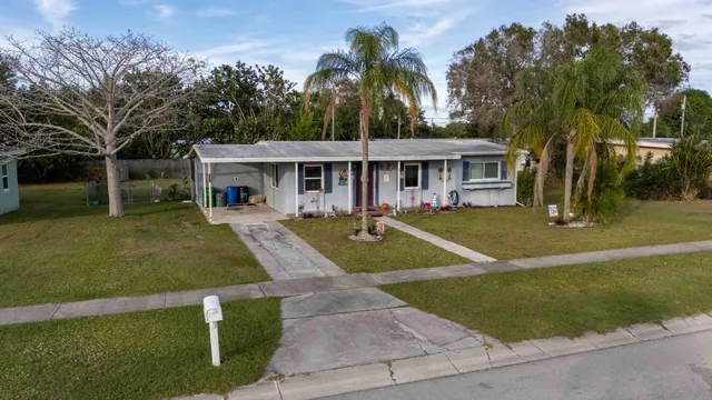 a view of house with outdoor space and swimming pool