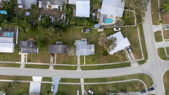 an aerial view of residential house with outdoor space and swimming pool