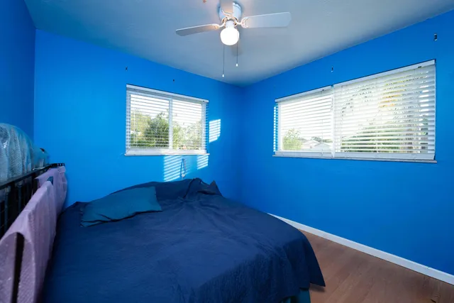 a bed sitting in a bedroom next to a window