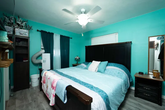 a bedroom with a bed and a chandelier