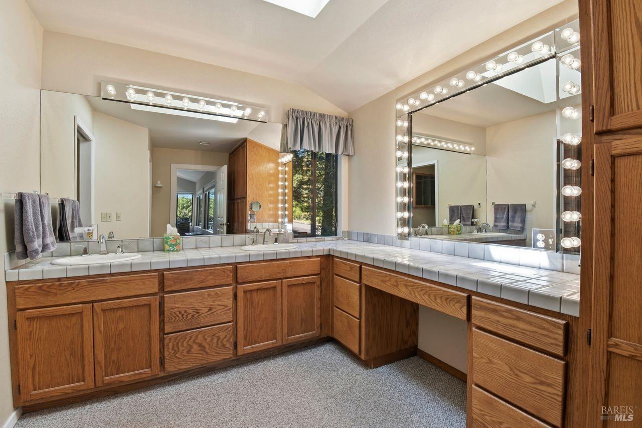 140 Massimo Circle Santa Rosa, CA 95404 - Photo 21 of 41 a bathroom with a granite countertop sink and a mirror
