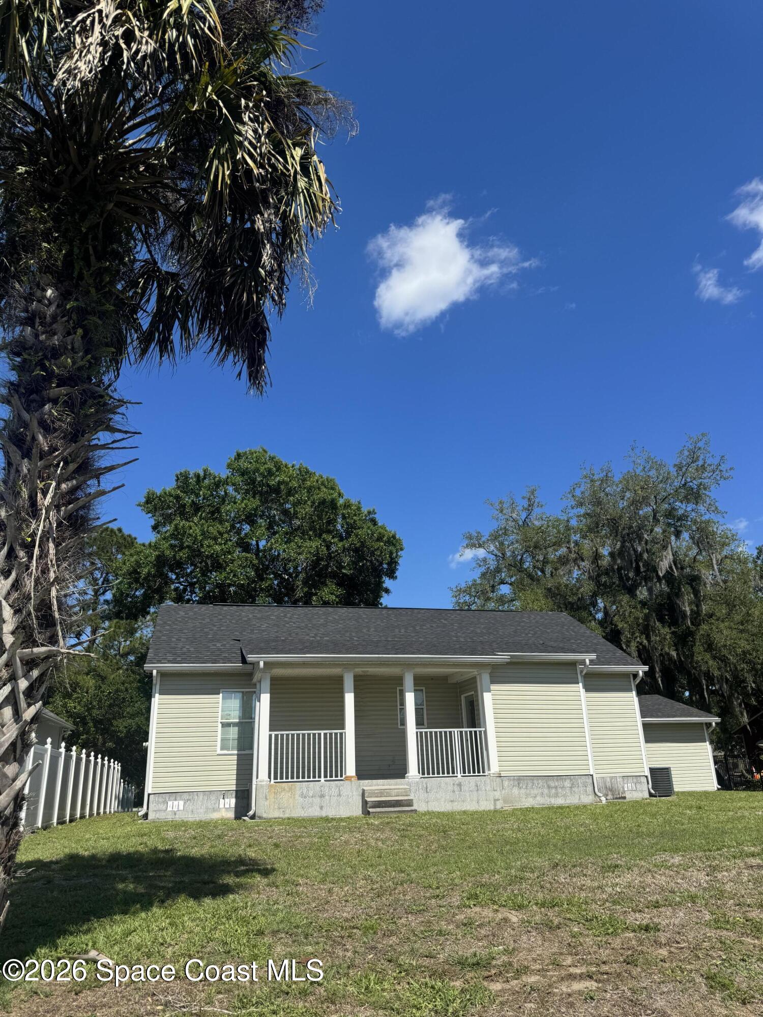 1130 Grapefruit Road Southeast Palm Bay, FL 32909 - Photo 14 of 14 a front view of a house with a garden