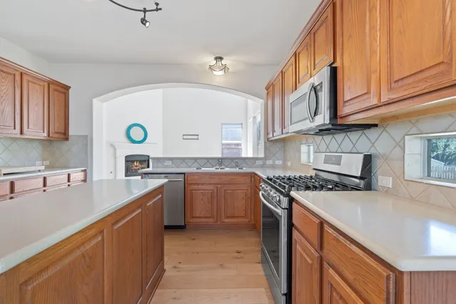 a kitchen with a sink a stove and cabinets