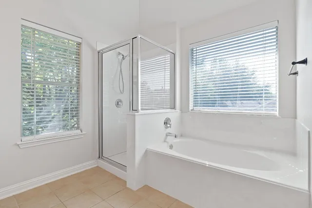 a bathroom with a bathtub and a shower