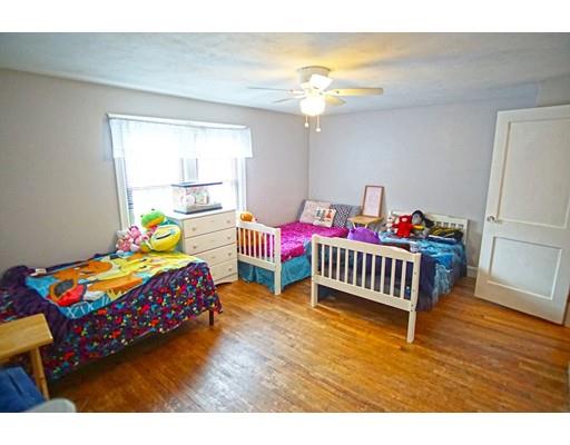 74 Oregon Street Springfield, MA 01118 - Photo 11 of 21 a bedroom with a bed and a wooden floor