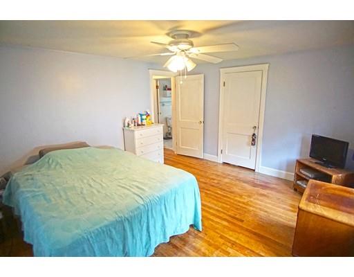 74 Oregon Street Springfield, MA 01118 - Photo 14 of 21 a bedroom with a bed and wooden floor