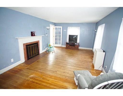 74 Oregon Street Springfield, MA 01118 - Photo 4 of 21 a living room with furniture and a fireplace