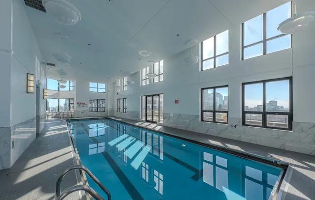 a large kitchen with kitchen island granite countertop a large window