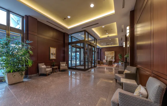 a lobby with furniture and potted plants