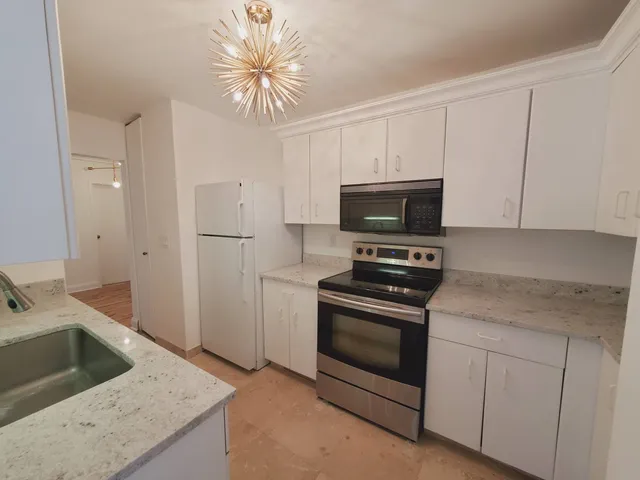 a kitchen with a sink stove and refrigerator