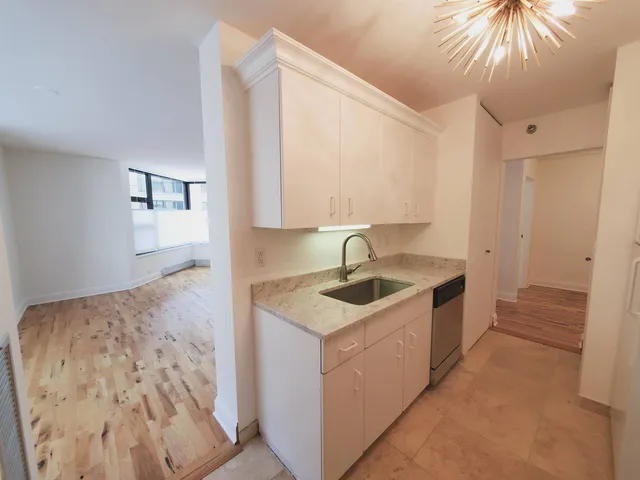 a kitchen with a sink and a refrigerator