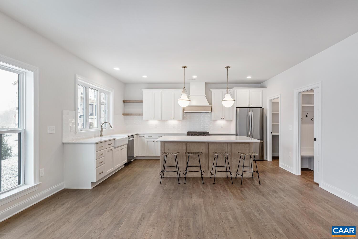 1731 Fowler Street Charlottesville, VA 22901 - Photo 14 of 54 a kitchen with stainless steel appliances a dining table chairs stove refrigerator and cabinets