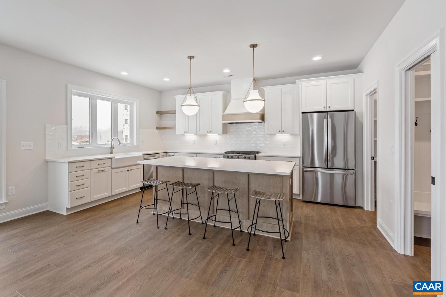 1731 Fowler Street Charlottesville, VA 22901 - Photo 15 of 54 a kitchen with stainless steel appliances granite countertop a refrigerator a sink dishwasher a stove and white cabinets with wooden floor