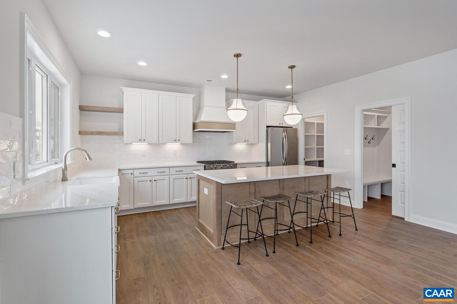 1731 Fowler Street Charlottesville, VA 22901 - Photo 19 of 54 a kitchen with stainless steel appliances granite countertop a sink a stove a refrigerator and a microwave with wooden floor
