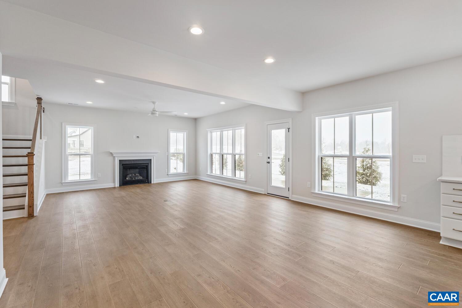 1731 Fowler Street Charlottesville, VA 22901 - Photo 22 of 54 an empty room with wooden floor and fireplace