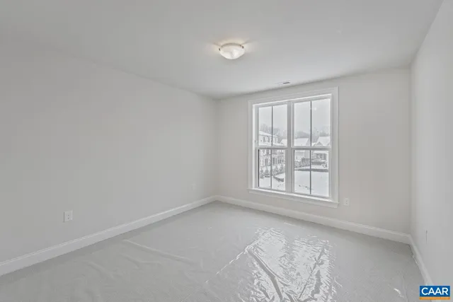 an empty room with closet and mirrors