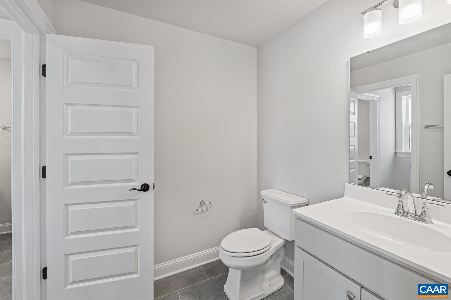 1731 Fowler Street Charlottesville, VA 22901 - Photo 39 of 54 a bathroom with a toilet a sink a vanity and mirror
