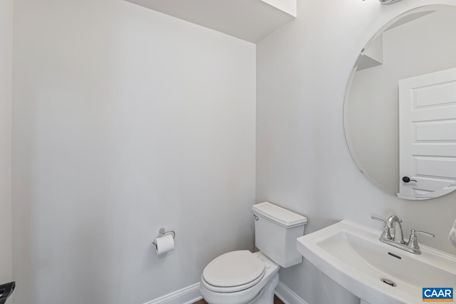 1731 Fowler Street Charlottesville, VA 22901 - Photo 42 of 54 a white toilet sitting next to a bathroom sink