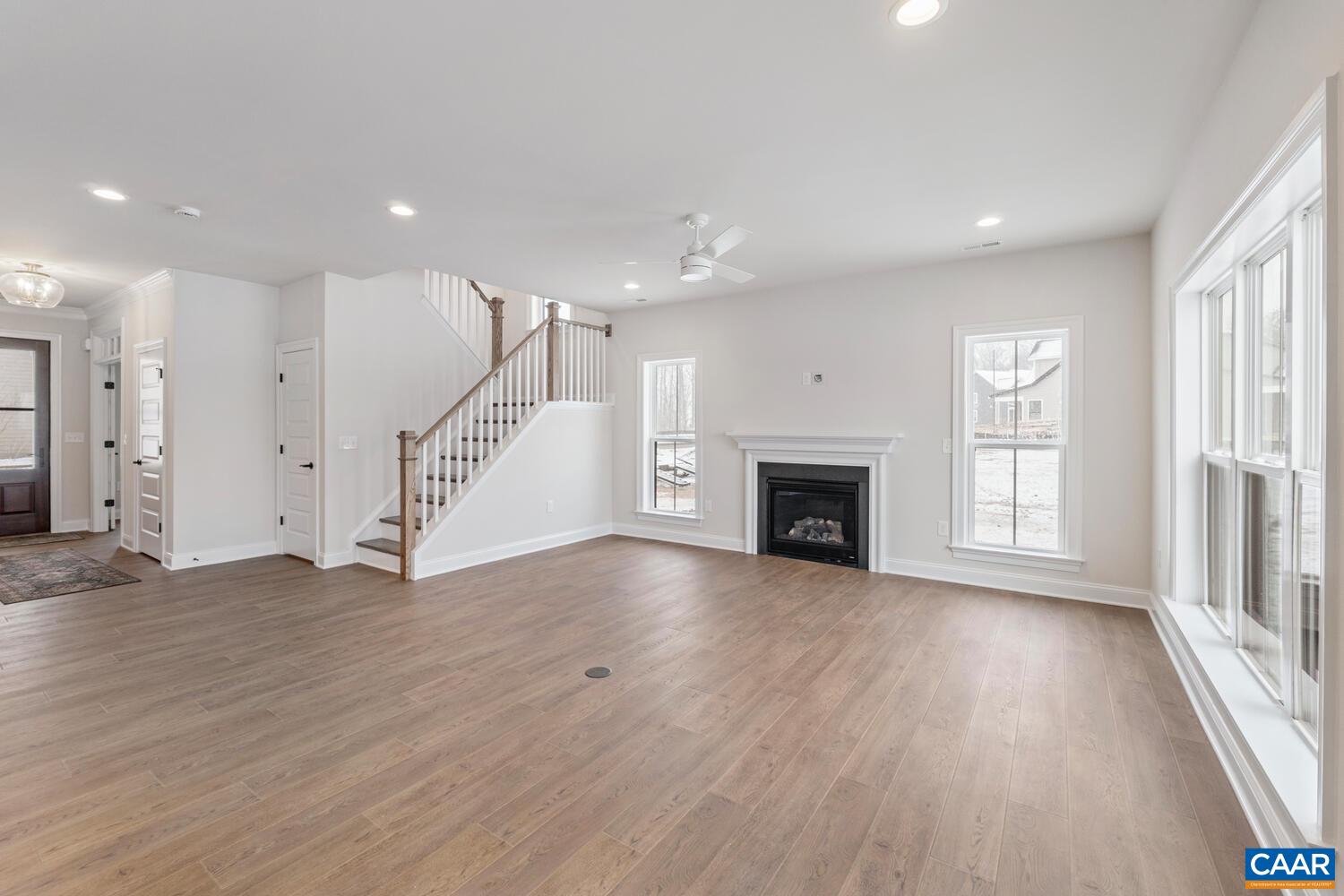 1731 Fowler Street Charlottesville, VA 22901 - Photo 10 of 54 an empty room with wooden floor fireplace and windows