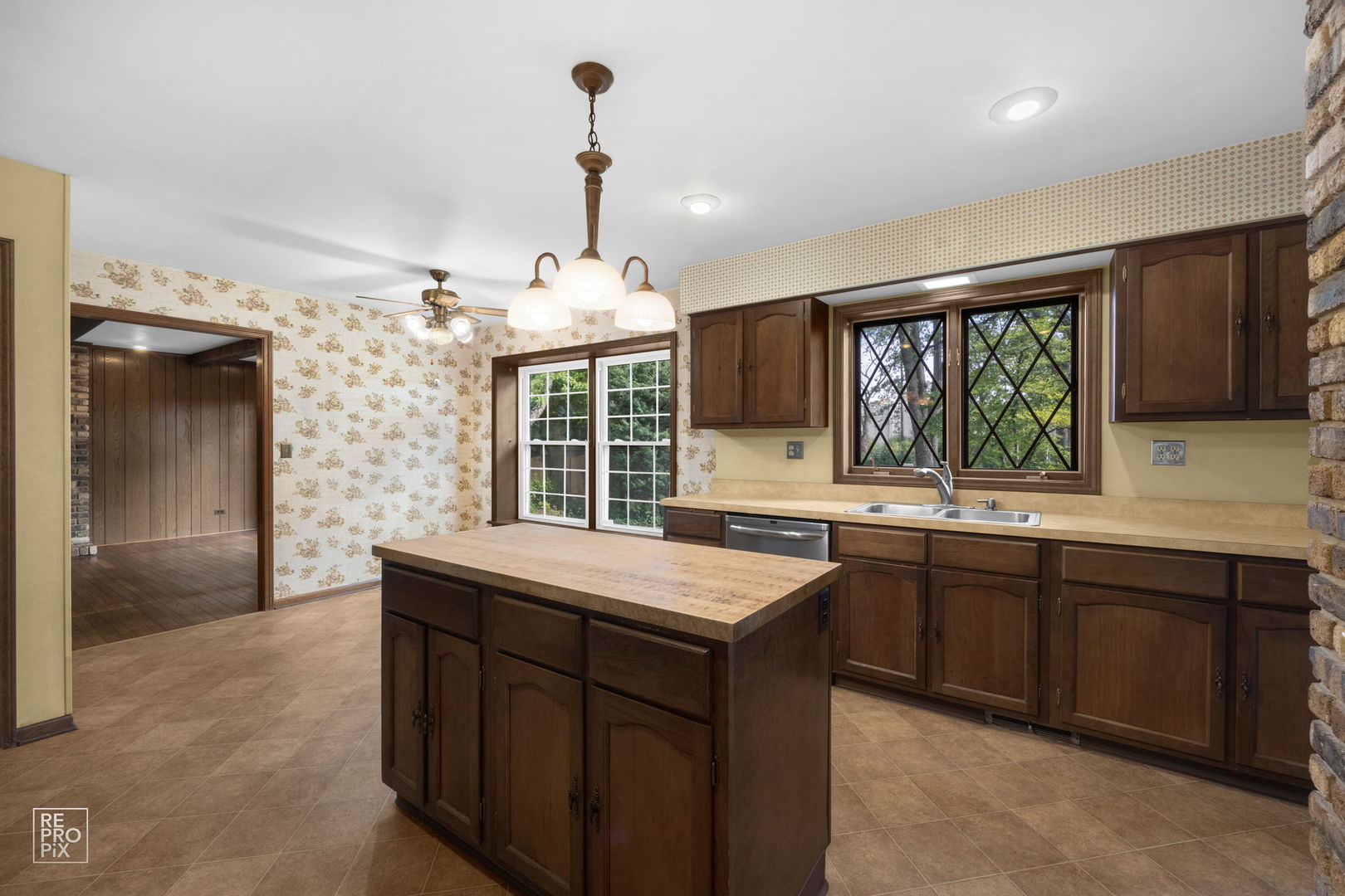 615 Harding Road Hinsdale, IL 60521 - Photo 11 of 32 a kitchen with kitchen island granite countertop a sink and dishwasher with a large window