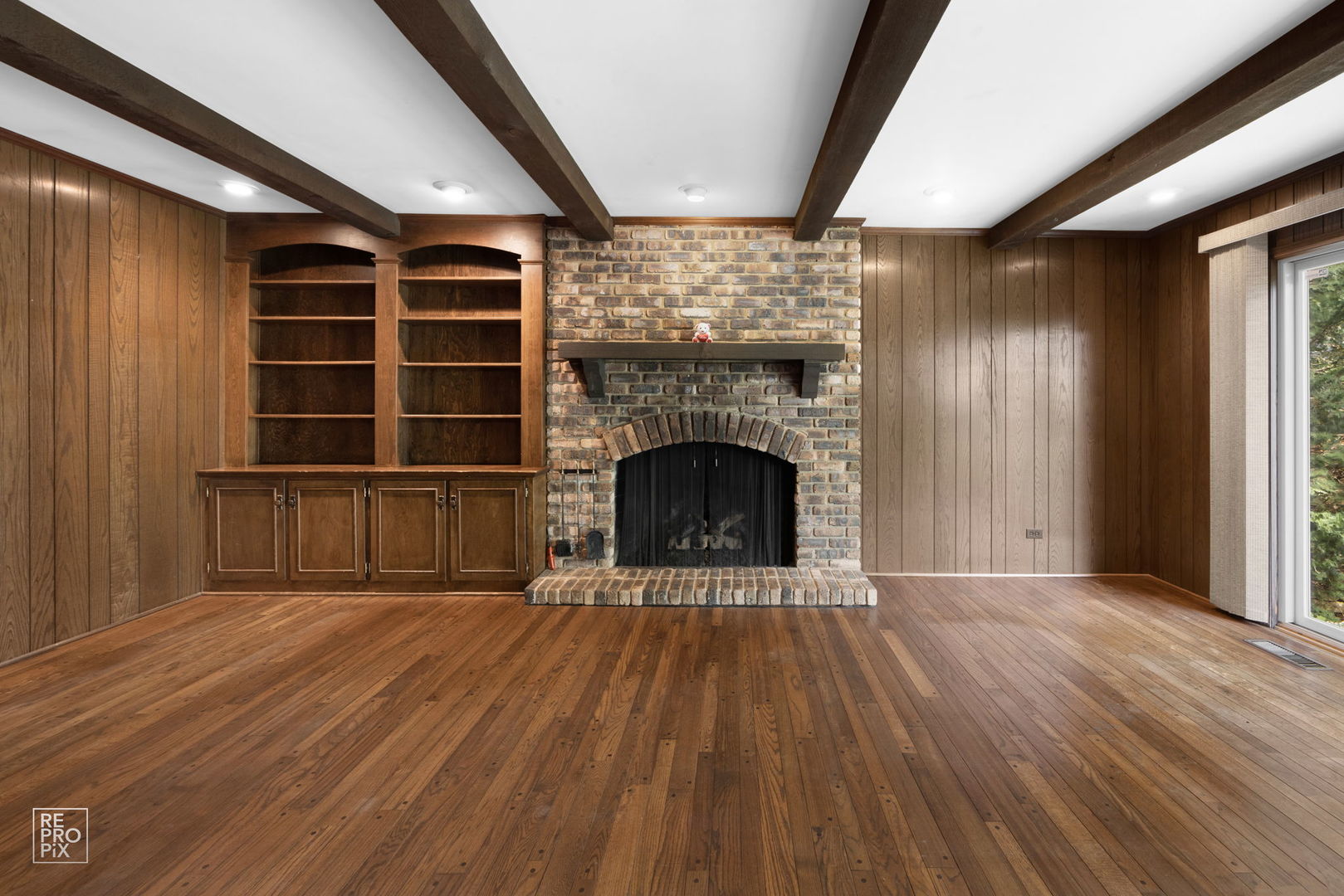 615 Harding Road Hinsdale, IL 60521 - Photo 14 of 32 a view of an empty room with wooden floor fireplace and a window