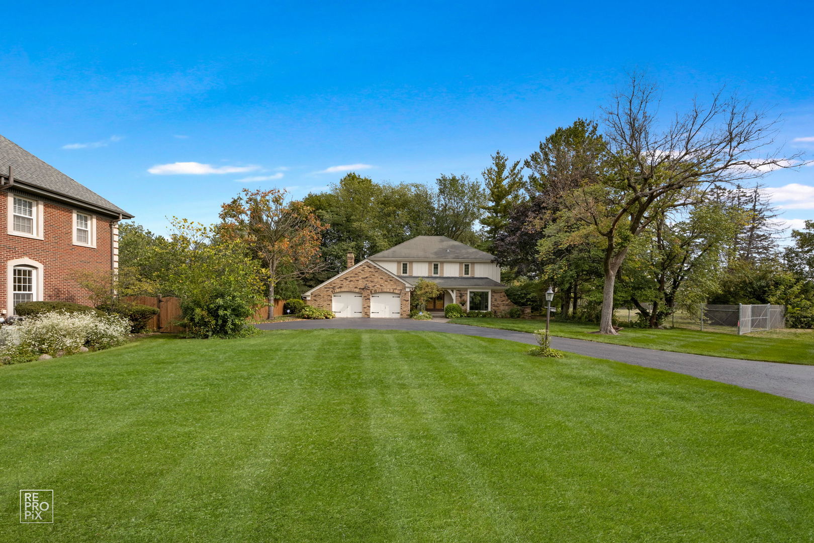 615 Harding Road Hinsdale, IL 60521 - Photo 2 of 32 a front view of a house with a yard and trees