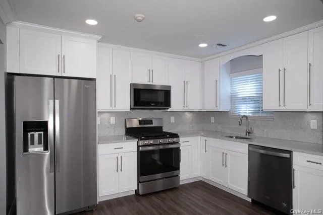 a kitchen with a refrigerator sink and microwave
