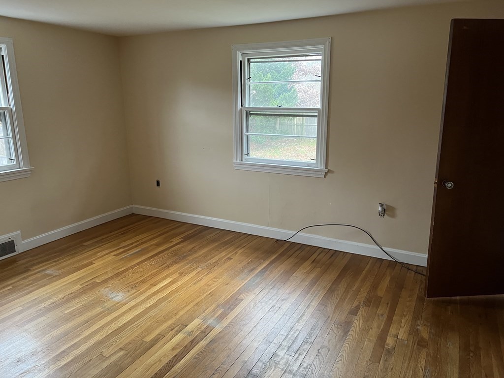 25 Margaret Road Hamilton, MA 01982 - Photo 12 of 33 a room with wooden floor and windows