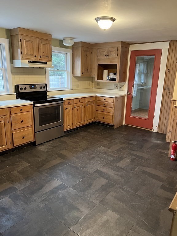25 Margaret Road Hamilton, MA 01982 - Photo 8 of 33 a kitchen with stainless steel appliances a stove top oven a sink a counter space and cabinets