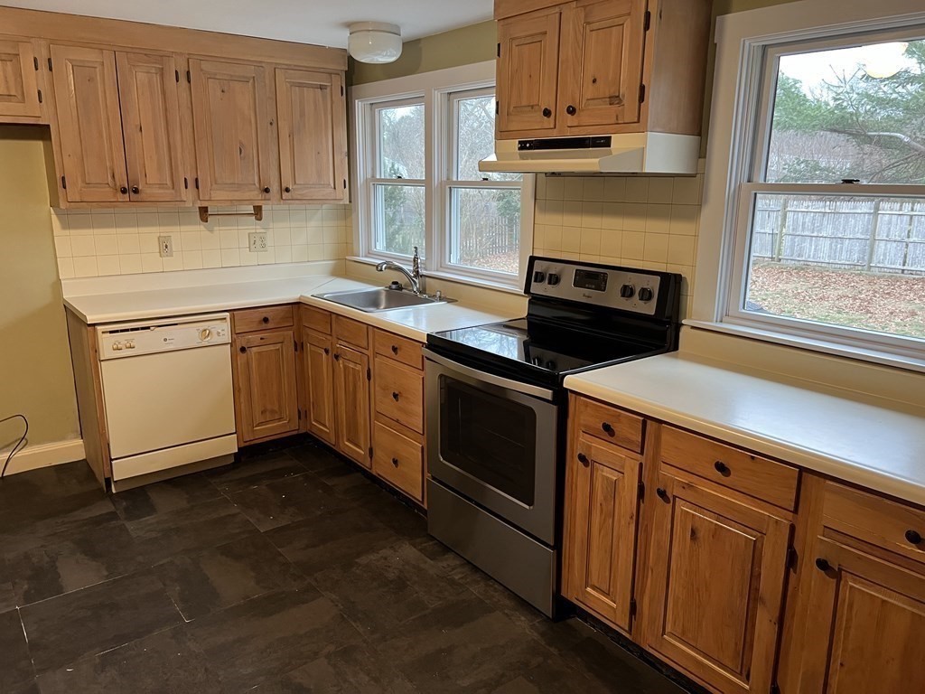 25 Margaret Road Hamilton, MA 01982 - Photo 9 of 33 a kitchen with granite countertop cabinets stainless steel appliances and a window