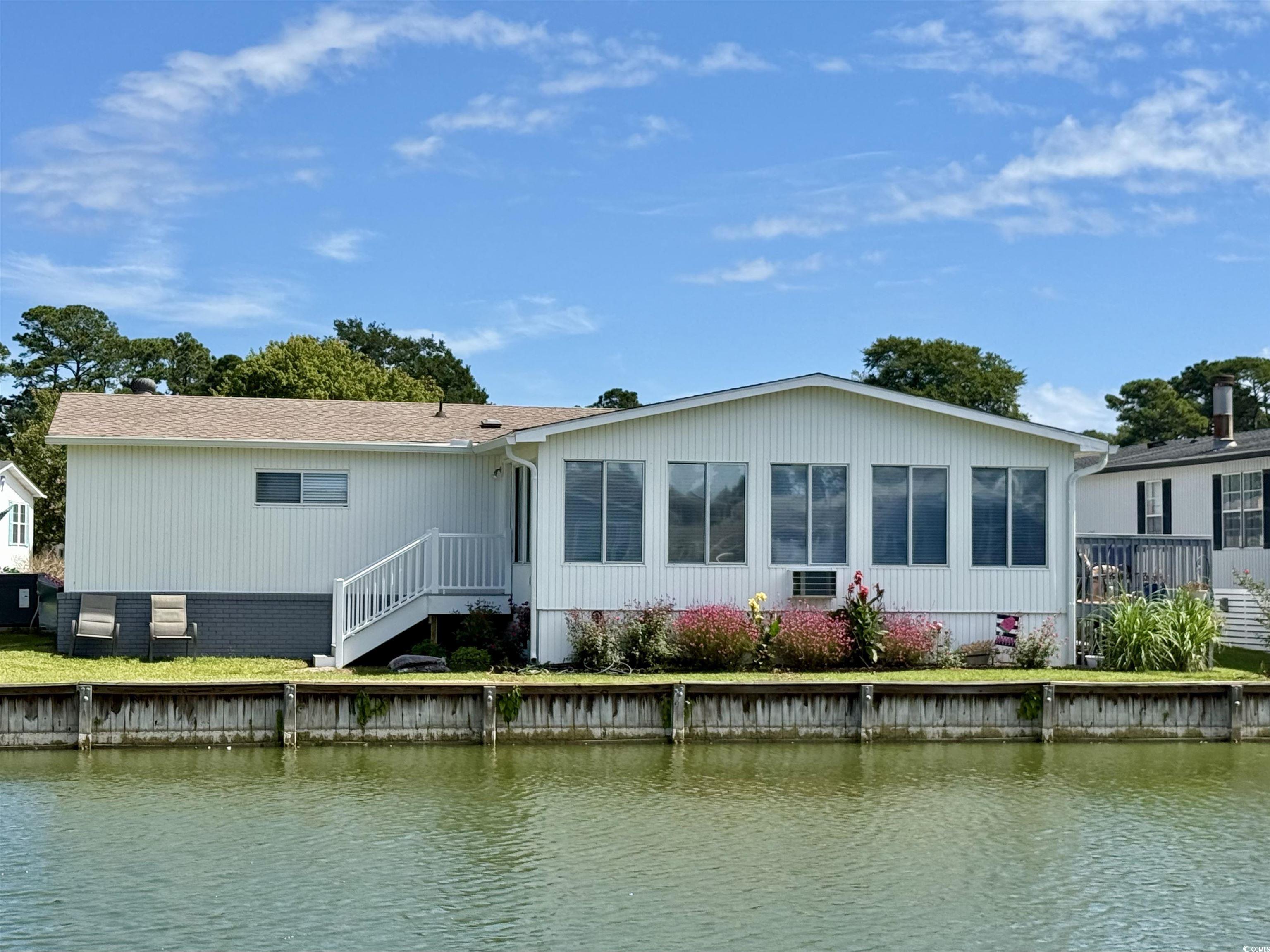 405 Twin Lakes Surfside Beach, SC 29575 - Photo 1 of 36 Back of house with a water view and a sunroom