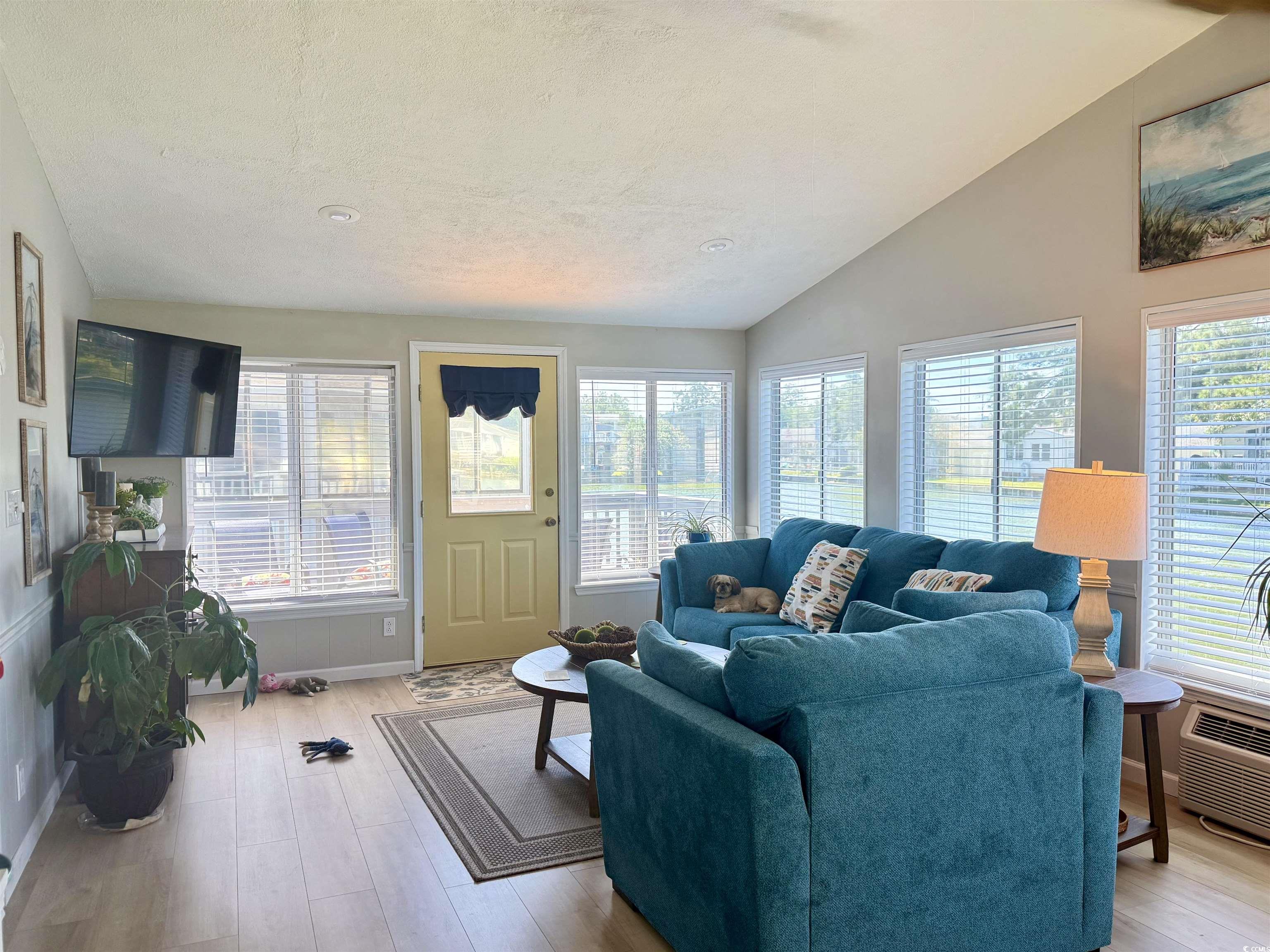 405 Twin Lakes Surfside Beach, SC 29575 - Photo 13 of 36 Living area with vaulted ceiling, light wood-style floors, and a textured ceiling